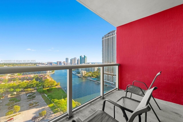 balcony featuring a view of city and a water view