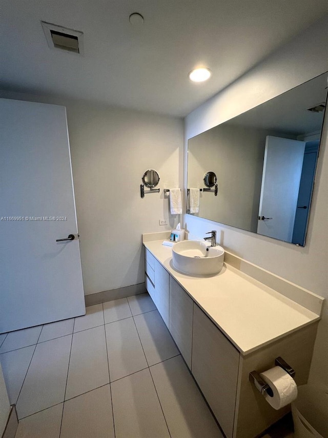 bathroom with tile patterned floors and vanity