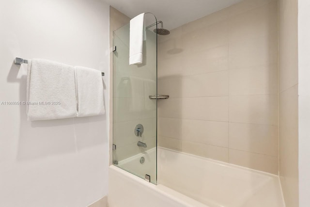 bathroom featuring shower / bath combination with glass door