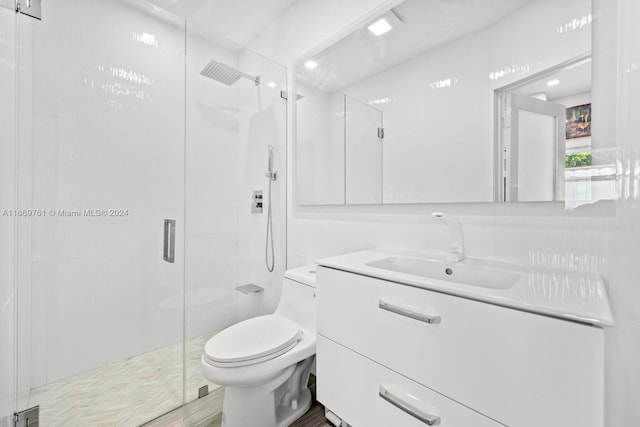 bathroom with hardwood / wood-style flooring, vanity, toilet, and an enclosed shower