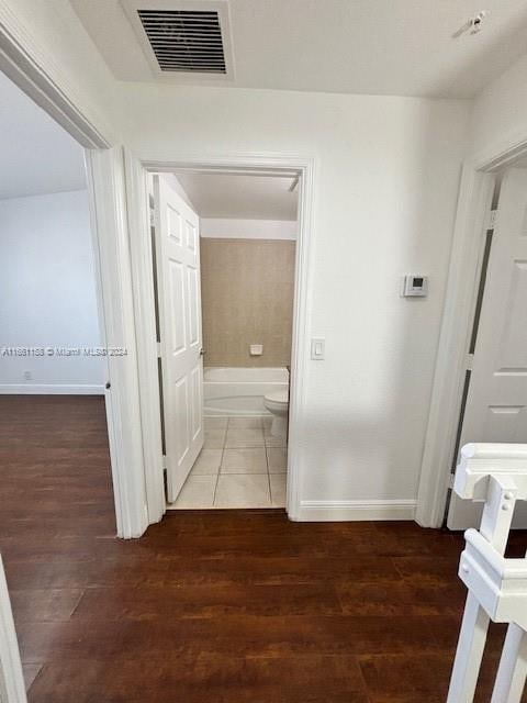 corridor featuring dark wood-type flooring