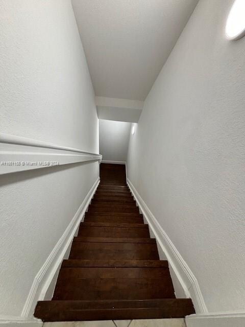 staircase featuring hardwood / wood-style flooring