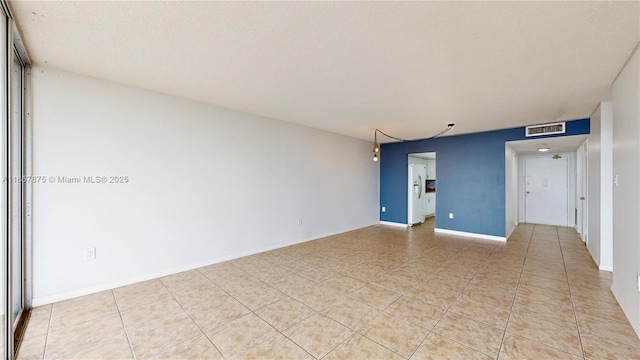 spare room featuring a textured ceiling