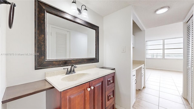 bathroom featuring vanity, tile patterned floors, and a textured ceiling