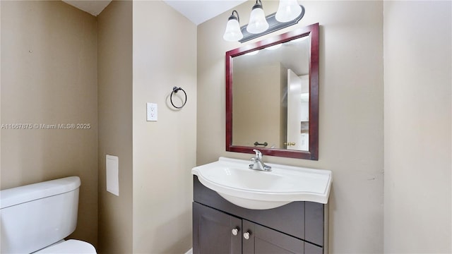 bathroom with toilet and vanity