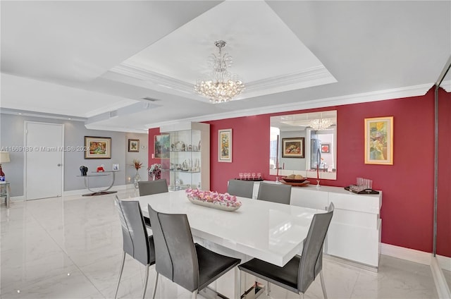 dining area with an inviting chandelier, a raised ceiling, and ornamental molding