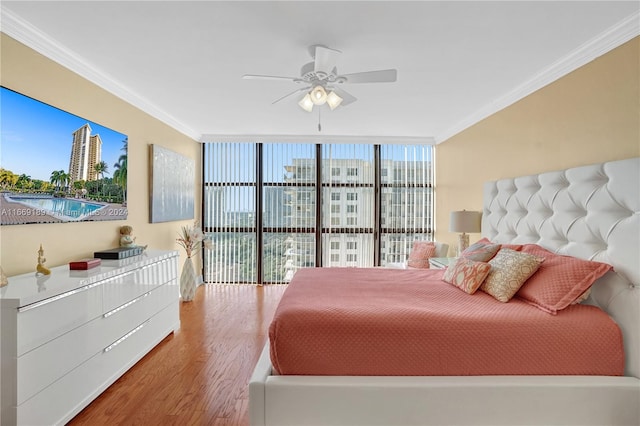 bedroom with floor to ceiling windows, ornamental molding, hardwood / wood-style floors, and ceiling fan