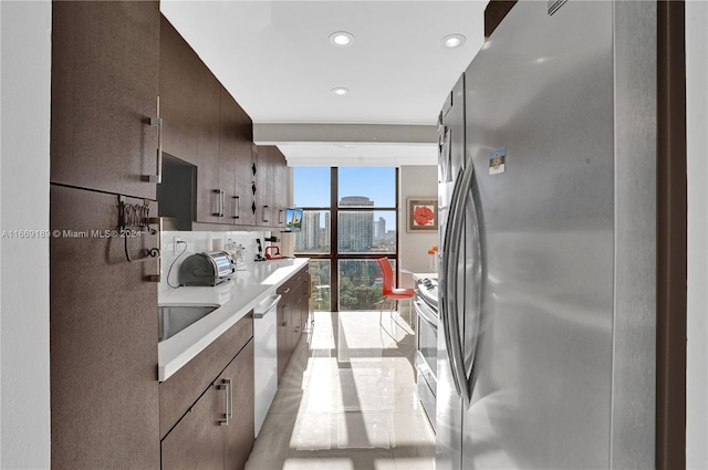 kitchen with a wall of windows and appliances with stainless steel finishes