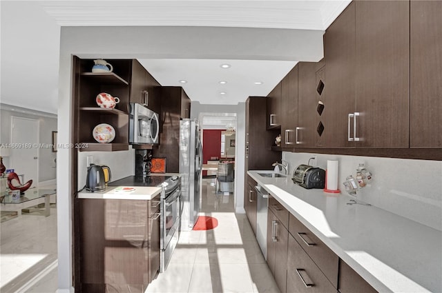 kitchen featuring dark brown cabinets, sink, appliances with stainless steel finishes, light tile patterned floors, and crown molding