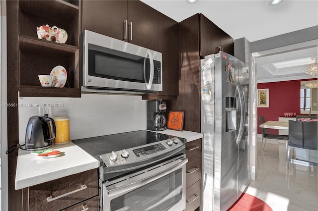 kitchen with dark brown cabinets, stainless steel appliances, a notable chandelier, and crown molding