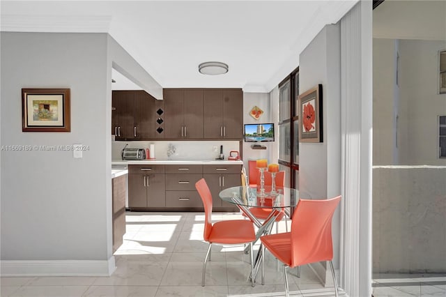 kitchen with dark brown cabinets and ornamental molding