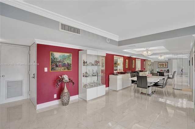 dining space with a notable chandelier, a raised ceiling, and ornamental molding