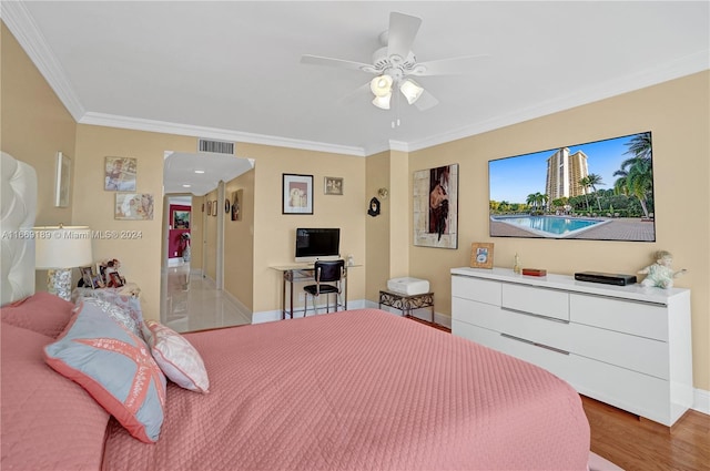 bedroom with crown molding, ceiling fan, and wood-type flooring