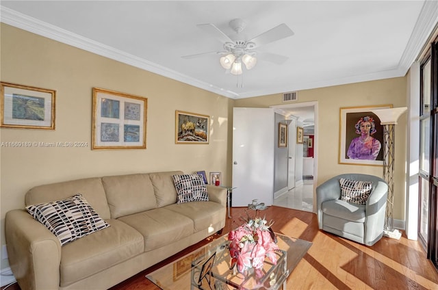 living room with crown molding, ceiling fan, and light hardwood / wood-style flooring