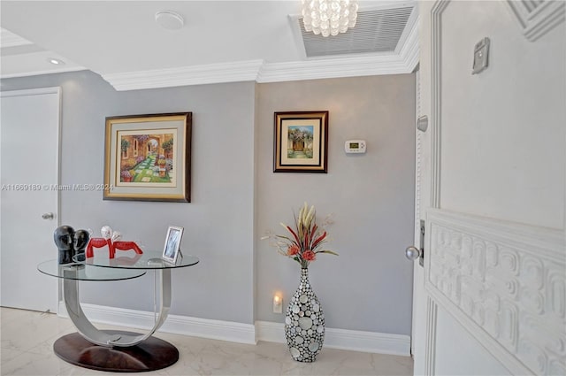 foyer featuring a notable chandelier and crown molding