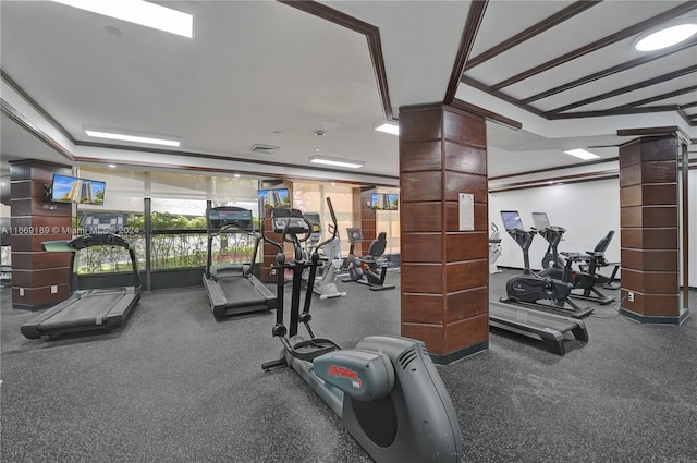 exercise room featuring expansive windows and decorative columns