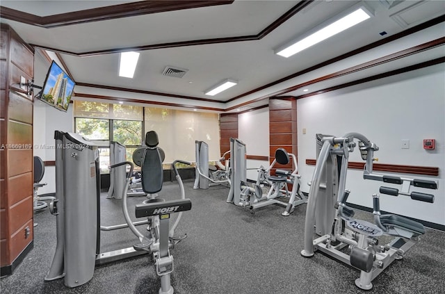 exercise room featuring crown molding