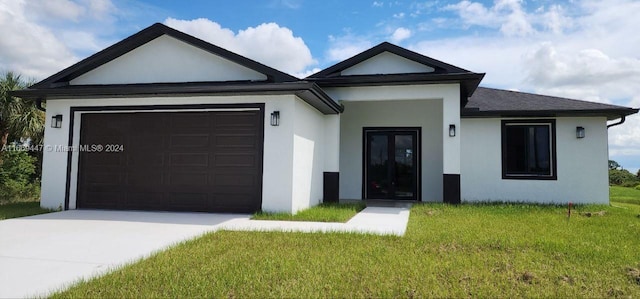 view of front of property with a front lawn and a garage