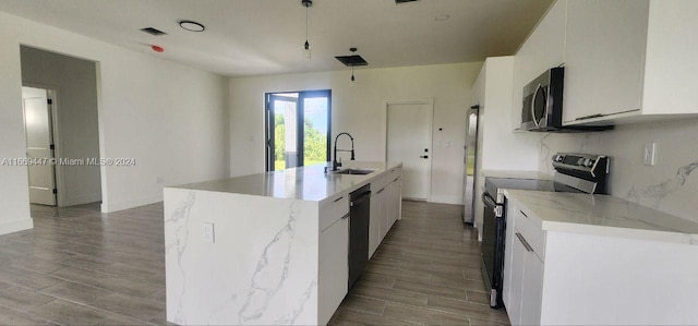 kitchen featuring an island with sink, black appliances, and white cabinetry