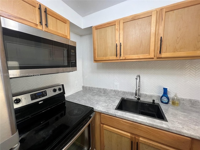 kitchen with backsplash, sink, and stainless steel appliances