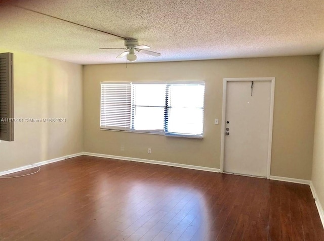 unfurnished room with a textured ceiling, dark hardwood / wood-style floors, and ceiling fan