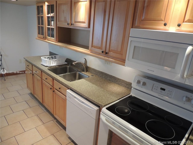 kitchen featuring sink, white appliances, and light tile patterned floors