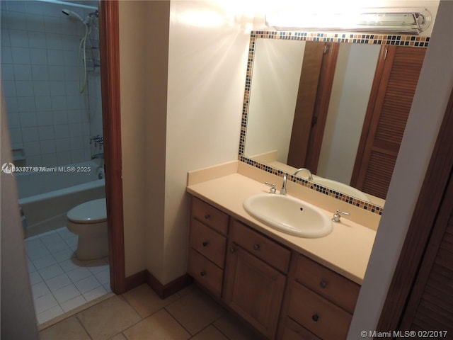 full bathroom featuring tile patterned floors, toilet, tiled shower / bath combo, and vanity