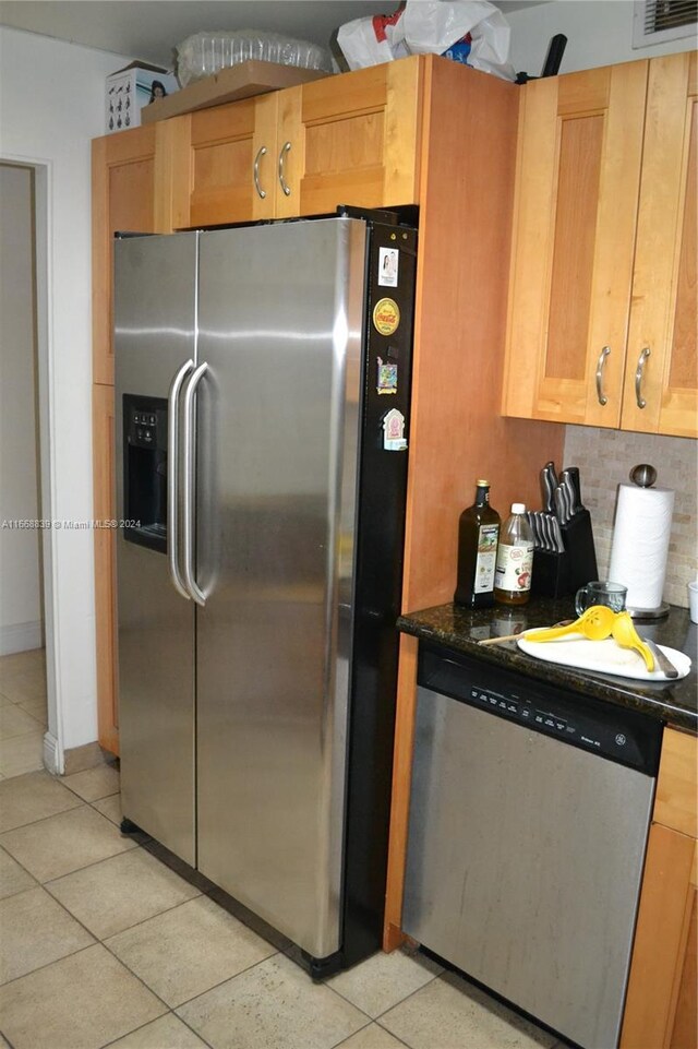 1050 93rd St Unit 7B, Bay Harbor Islands, FL 33154 - kitchen featuring tasteful backsplash, baseboards, light tile patterned floors, visible vents, and appliances with stainless steel finishes