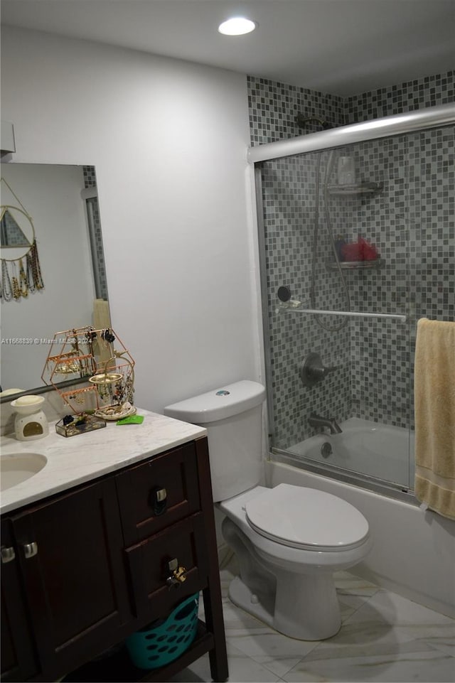 full bathroom featuring combined bath / shower with glass door, vanity, and toilet