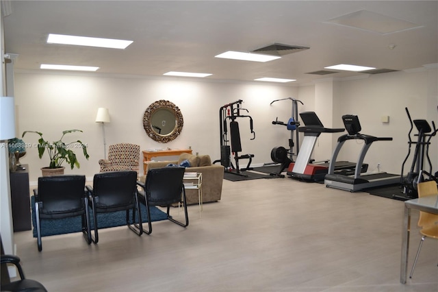 workout area with light hardwood / wood-style flooring