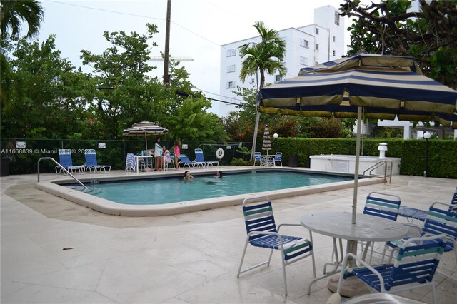 1050 93rd St Unit 7B, Bay Harbor Islands, FL 33154 - pool featuring a patio and fence