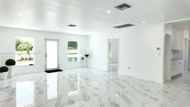 kitchen with kitchen peninsula, white cabinetry, sink, and appliances with stainless steel finishes