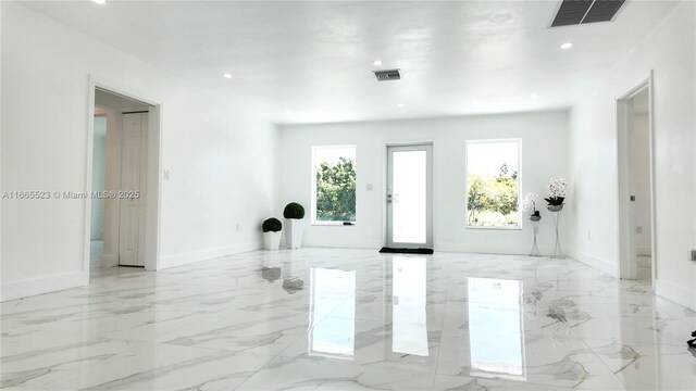 kitchen featuring sink, stainless steel appliances, light stone counters, decorative backsplash, and white cabinets