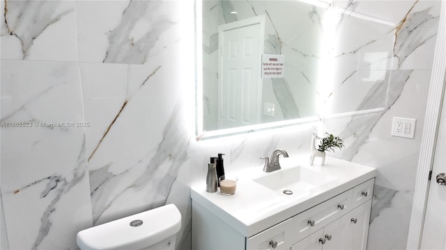 bathroom with vanity, backsplash, tile walls, and toilet