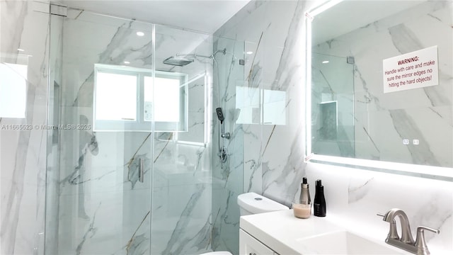 bathroom featuring vanity, tile walls, toilet, and walk in shower