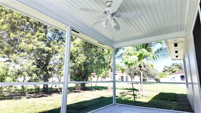 unfurnished sunroom with ceiling fan