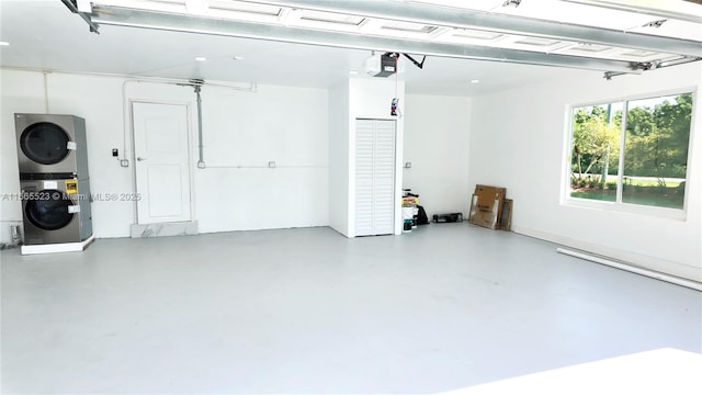 garage featuring stacked washer and dryer and a garage door opener