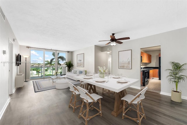 dining room with a textured ceiling, ceiling fan, and dark wood-type flooring