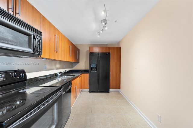 kitchen with track lighting, sink, light tile patterned floors, and black appliances