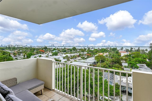 balcony featuring a view of city and a water view