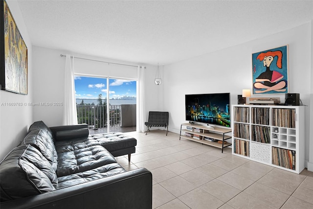 living room with a textured ceiling and tile patterned floors