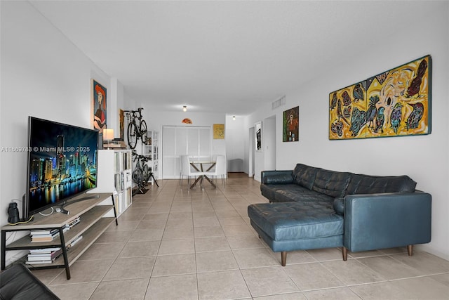 living area featuring visible vents and light tile patterned floors