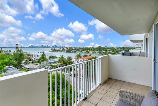 balcony featuring a water view and a view of city