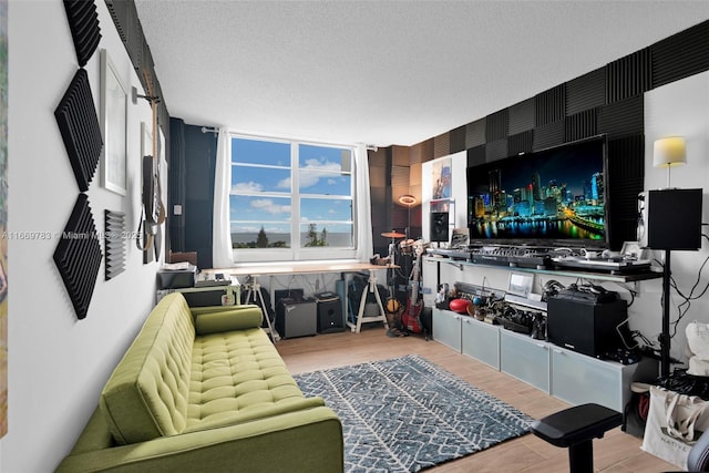 living area with a textured ceiling and wood finished floors