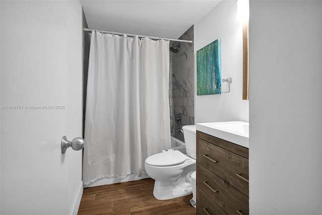 bathroom featuring shower / bath combo, vanity, toilet, and wood finished floors