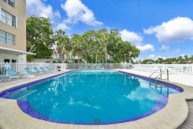 pool featuring a patio and fence