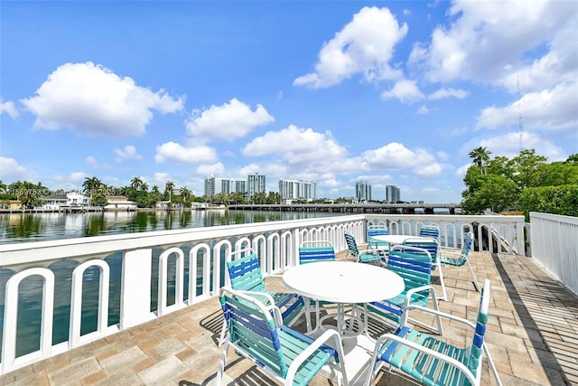 view of patio featuring a water view and a city view