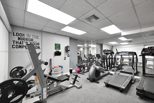 gym with a paneled ceiling and visible vents