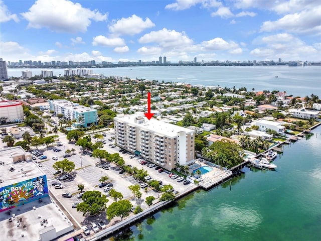 drone / aerial view featuring a view of city and a water view