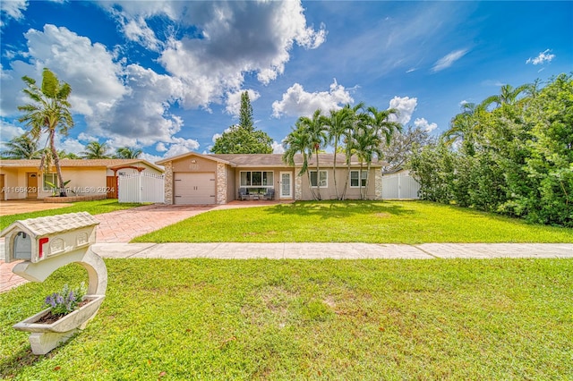 ranch-style home featuring a front lawn and a garage